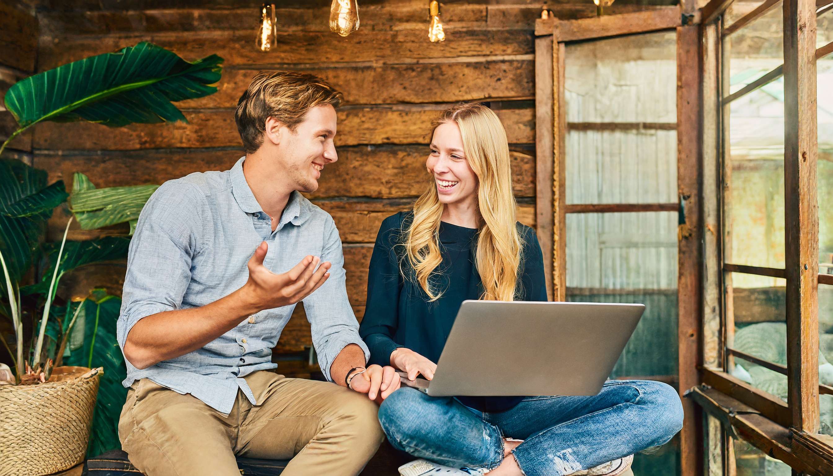 Firefly Two people in business casual clothing have an excited, upbeat discussion in a rustic, comfo