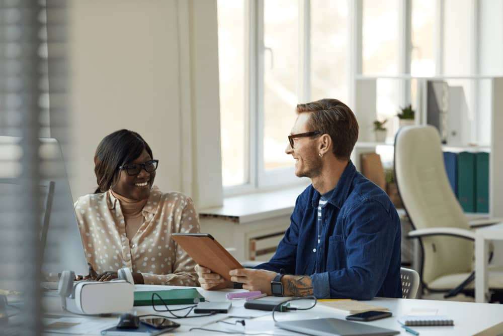 people happily working in education office